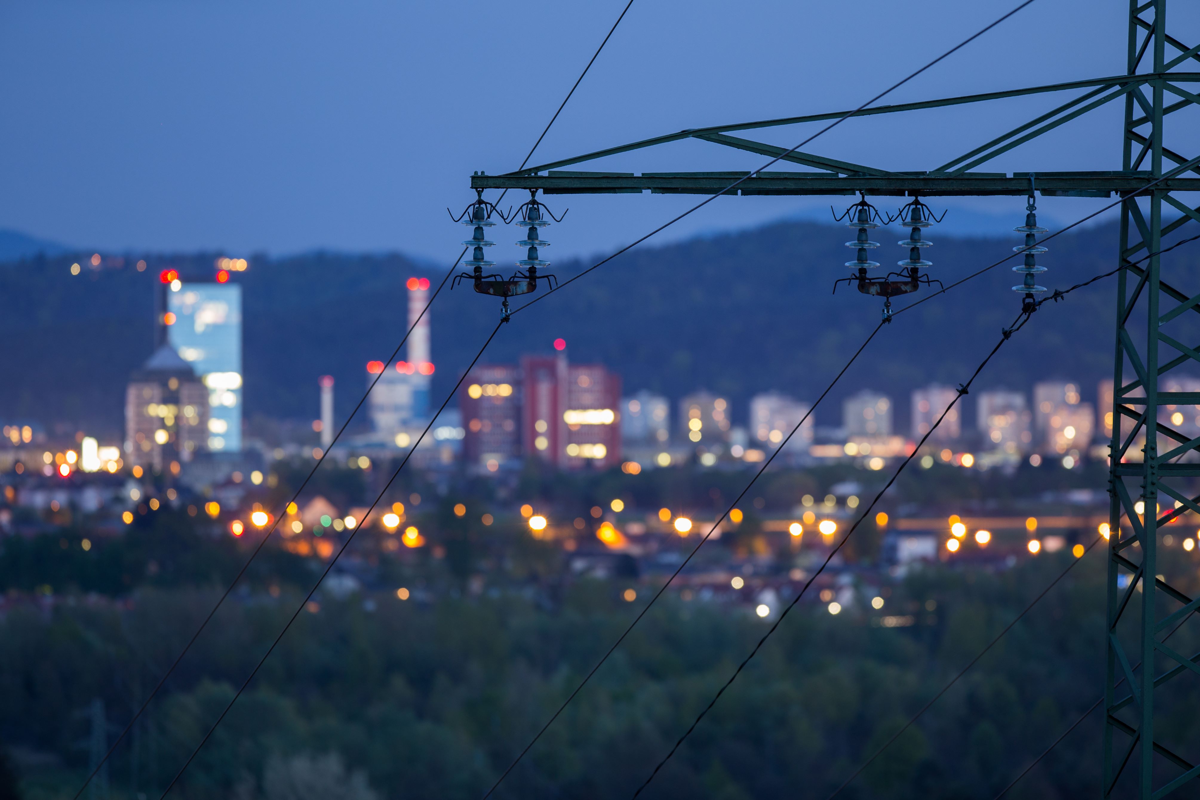 A transmission tower in front of a city